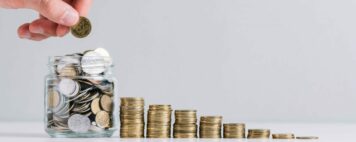 ascending stacks of coins with a person adding to a jar of coins to symbolize their donation