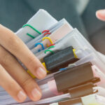 person looking through a stack of papers