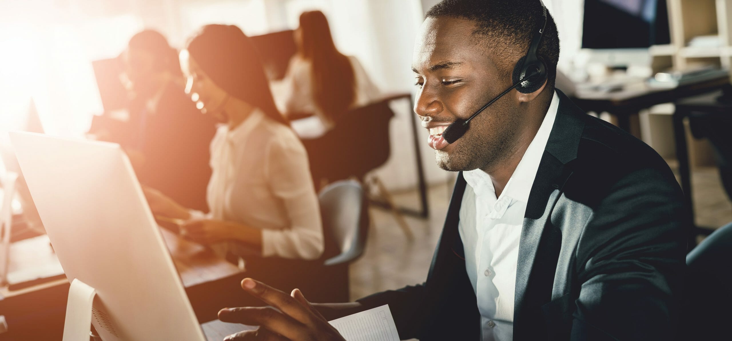 man on the phone and laughing with the customer he is speaking with