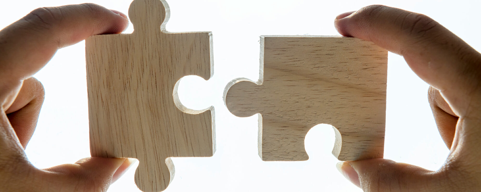 puzzle-pieces Hands putting puzzle pieces together