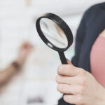 woman holding a magnifying glass