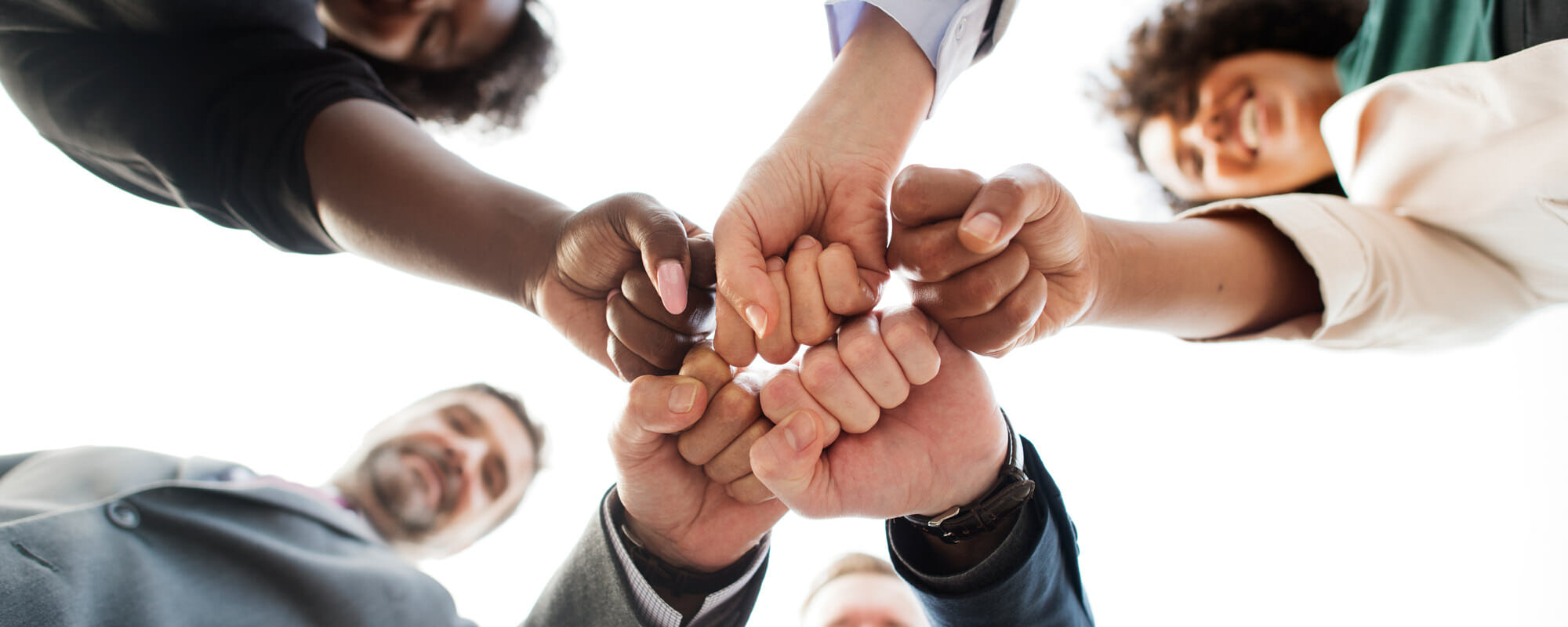 Diverse hands bumping knuckles