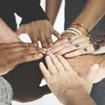 Diverse peoples hands together