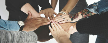Diverse peoples hands together