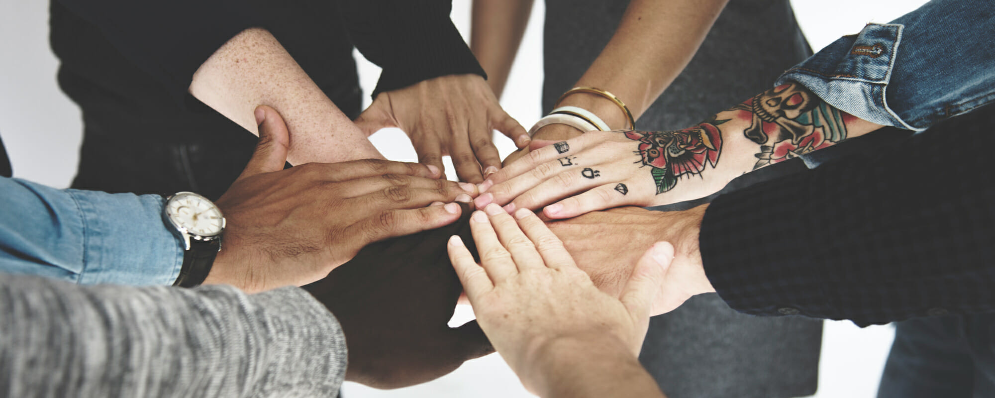 Diverse peoples hands together