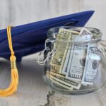 Graduation cap next to a jar of money