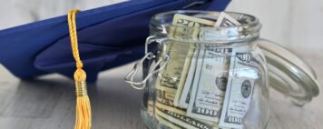 Graduation cap next to a jar of money