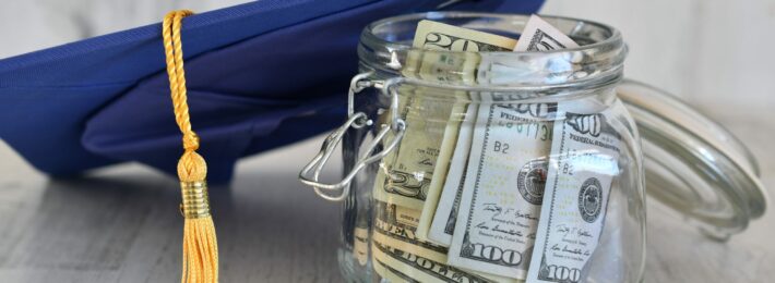 Graduation cap next to a jar of money