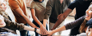 Diverse people stacking hands