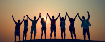Friends gathered and holding hands up