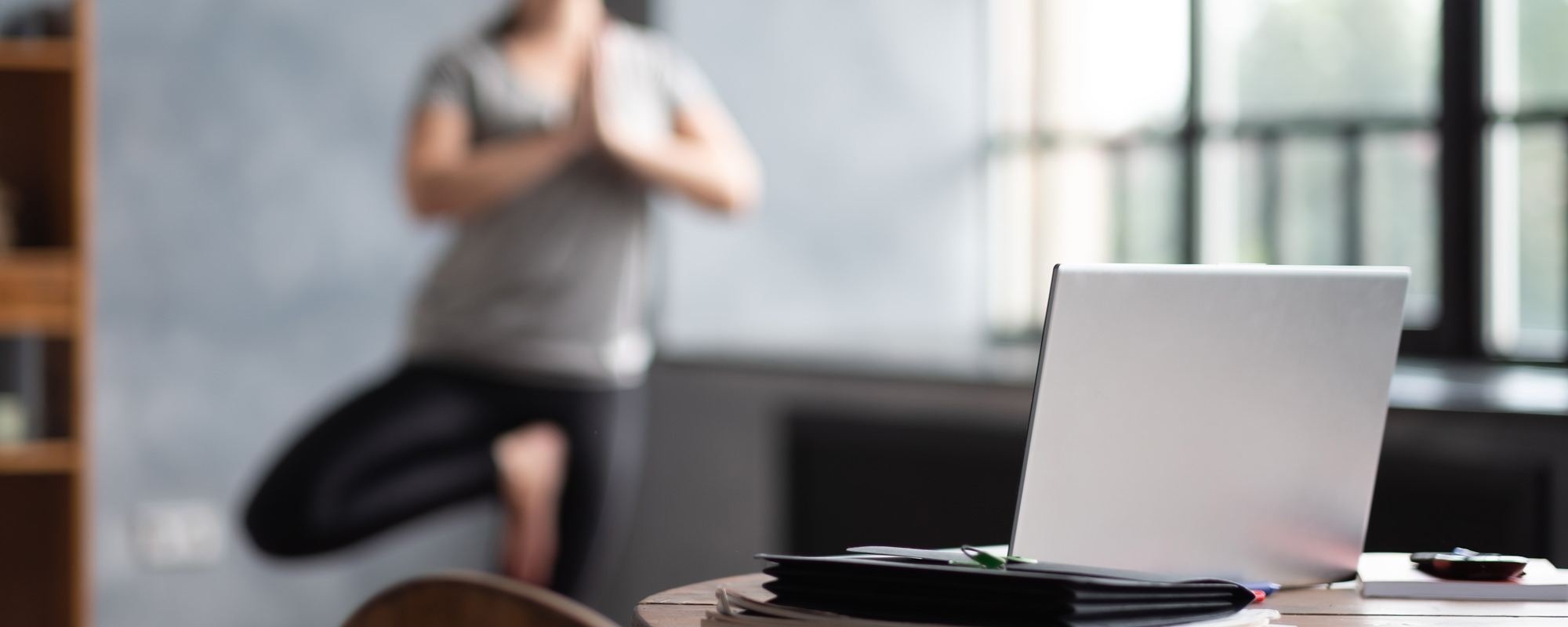 Doing yoga in front a laptop