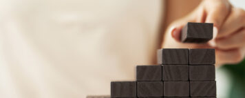 Person stacking wooden blocks