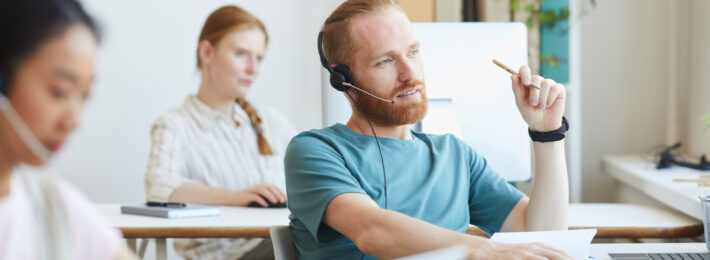 Customer service man on a headset talking to a customer