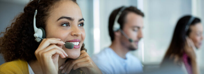 Customer service representative talking to a customer on her headphones
