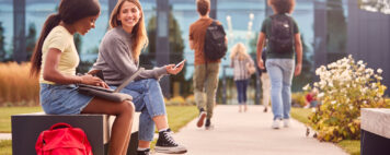 Students sitting outside on campus