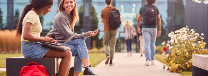 Students sitting outside on campus